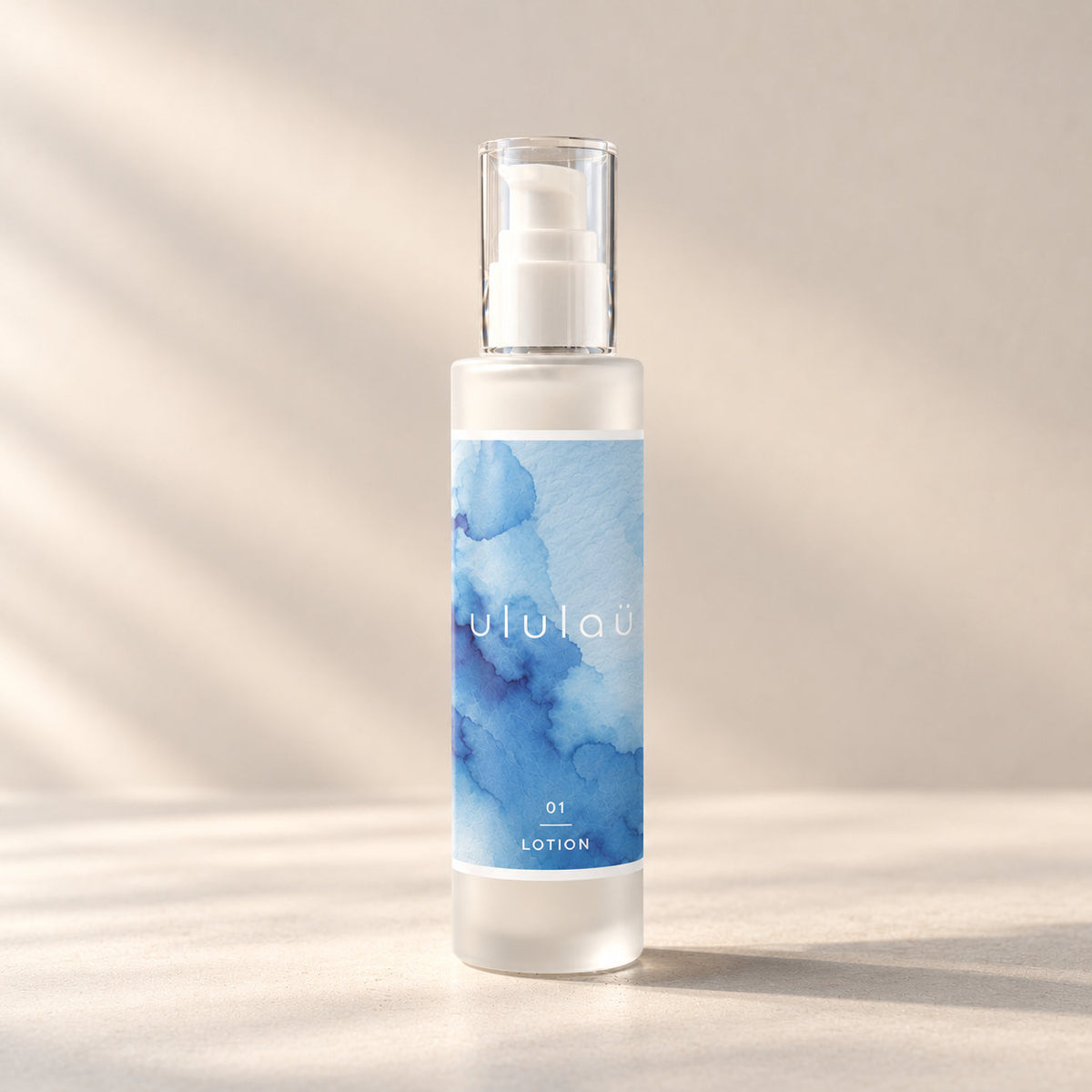 砂色の背景に立つ、01 LOTIONのボトル